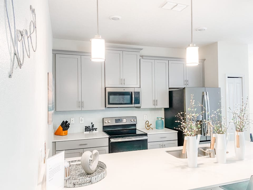 Beautiful kitchen with pots and pans, coffee maker, utensils, glasses, etc