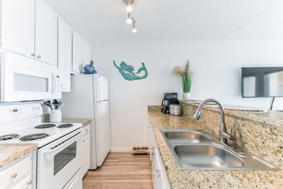 Renovated kitchen with granite countertops and full size appliances.