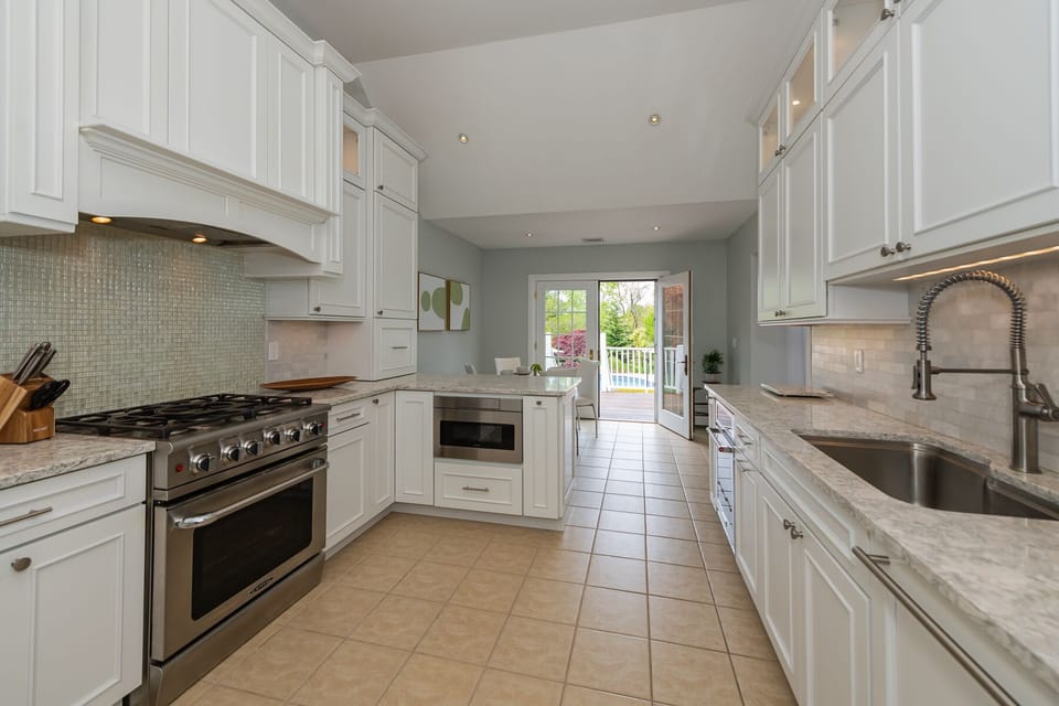 Chef's Kitchen, breakfast table and doors to BBQ and backyard.