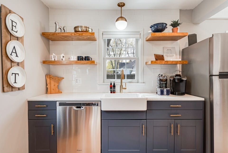 Your stylish kitchen features modern appliances, warm wood shelving, and everything you need to create delicious meals during your stay.