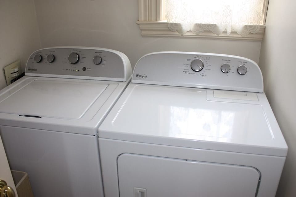 Clothing washer and Dryer.  Laundry detergent is provided. Iron and board too.