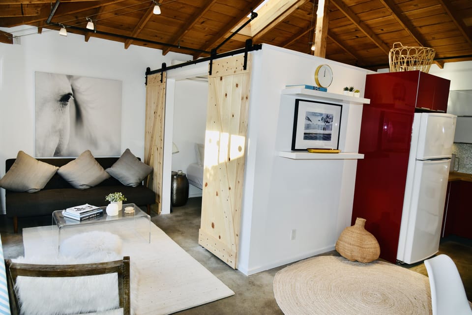 Living room. Sofa bed. Main bedroom w/ sliding doors. Kitchen to the right