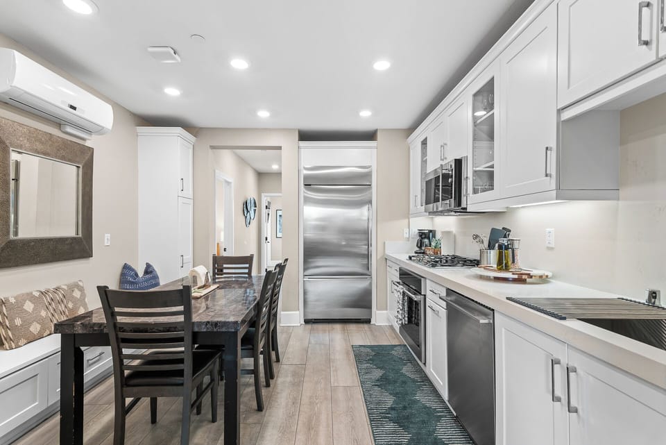 Open-concept kitchen and dining area featuring modern appliances, a spacious dining table, and plenty of room to cook, share meals, and enjoy time together.