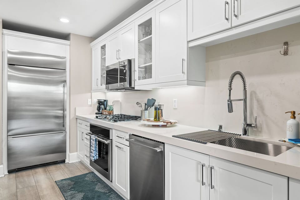 Open-concept kitchen and dining area featuring modern appliances, a spacious dining table, and plenty of room to cook, share meals, and enjoy time together.