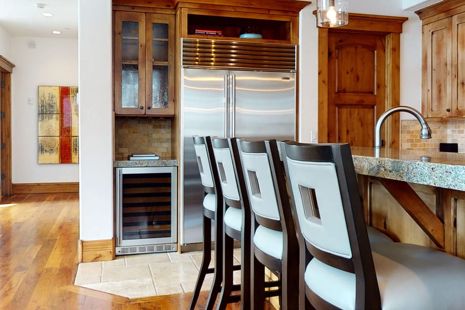 Gourmet Kitchen with granite countertops, Sub-Zero fridge, stainless steel Wolff appliances, bar seating for four, and wine fridge