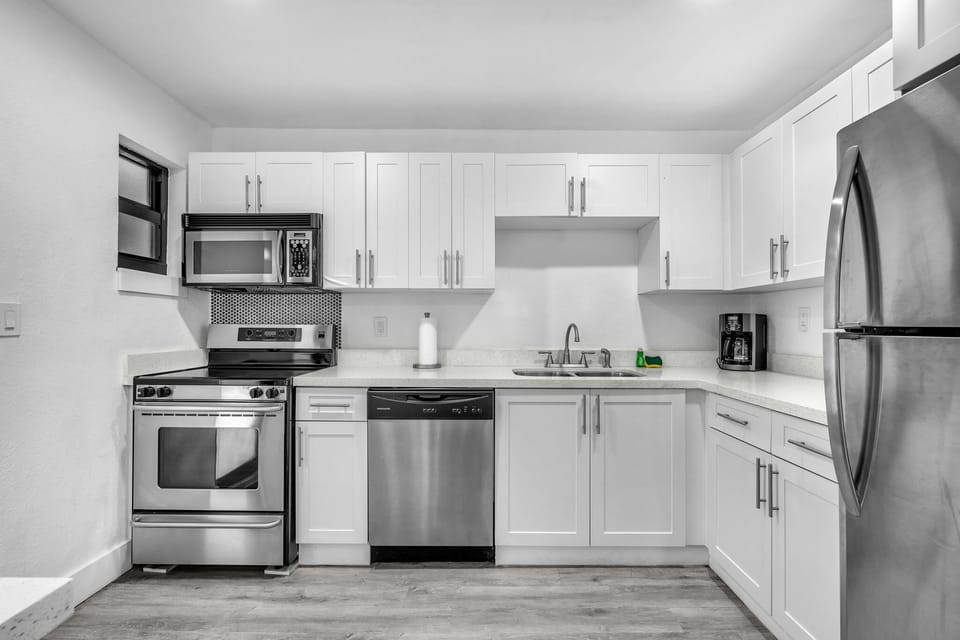 The kitchen boasts ample space, essential appliances, and abundant storage options.