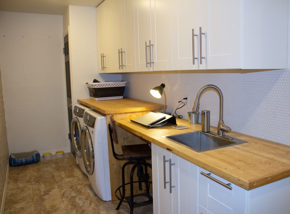 The laundry room is fully stocked, with five Rae Dunn dog bowls for pets. A quiet work station with surge protection and USB ports is also available if you need to work during your stay.
