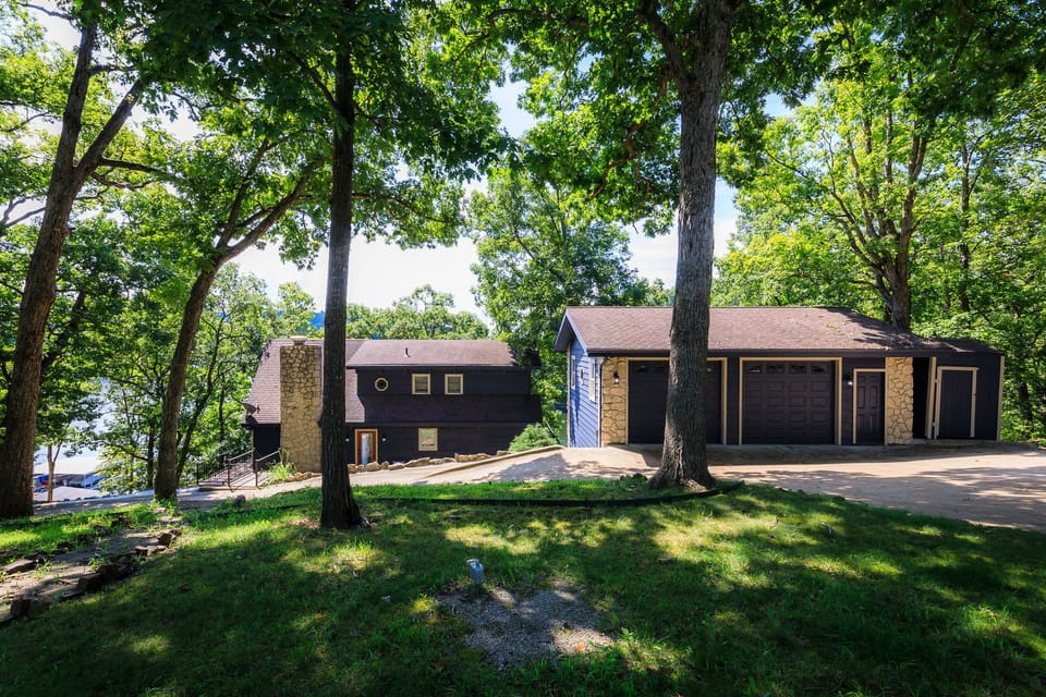 Front view of house with circular driveway and guest house