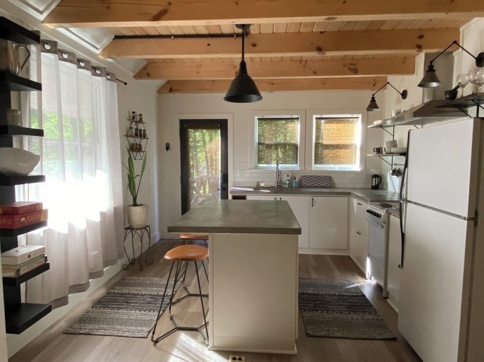 Seated island area with a concrete countertop. Great for gathering and cooking!