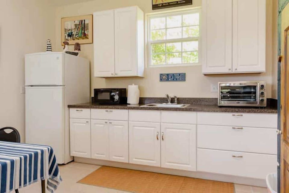 Full refrigerator and table to eat at or play cards, do a puzzle