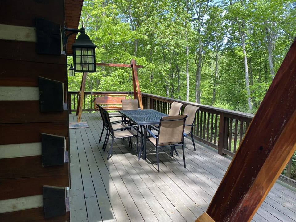 outdoor dining with two swings on the deck