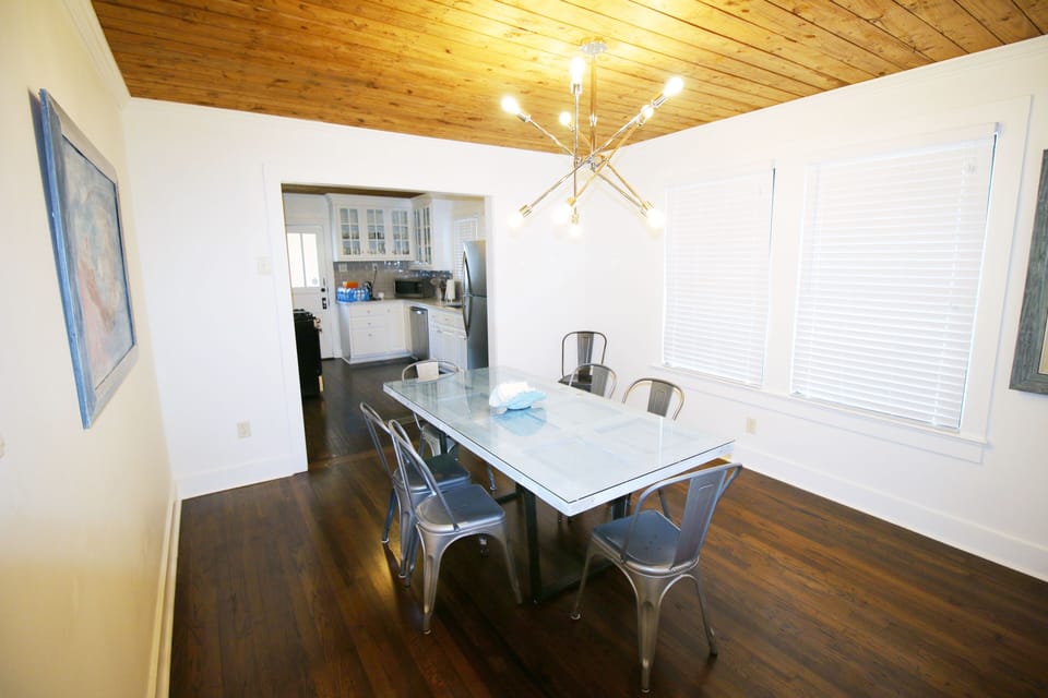Dining room with dimmable modern fixture with Edison bulbs.