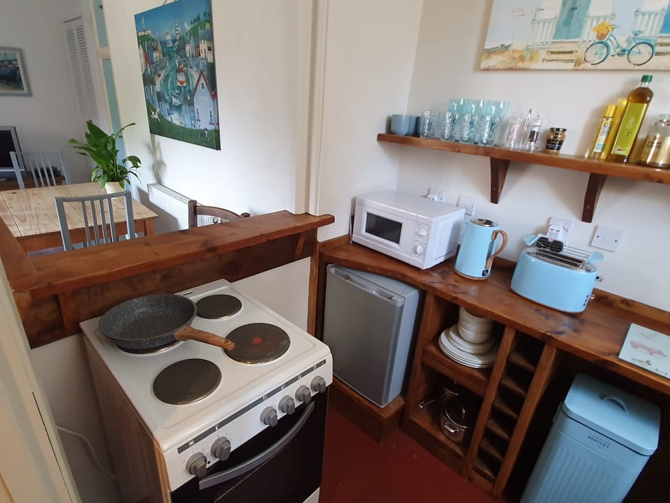 Open to sitting room | Cooker | Microwave | Fridge | Toaster | Ketttle