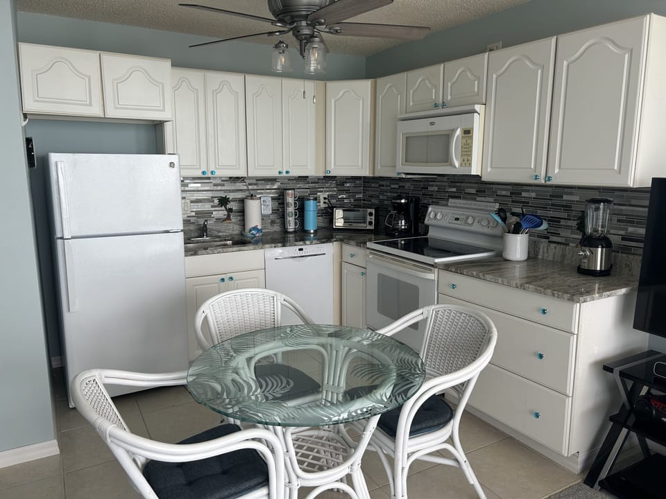 Light and bright full kitchen with table and chairs