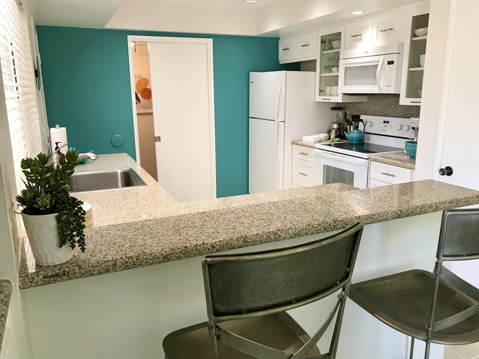Laundry room with a stack washer and dryer for your convenience!