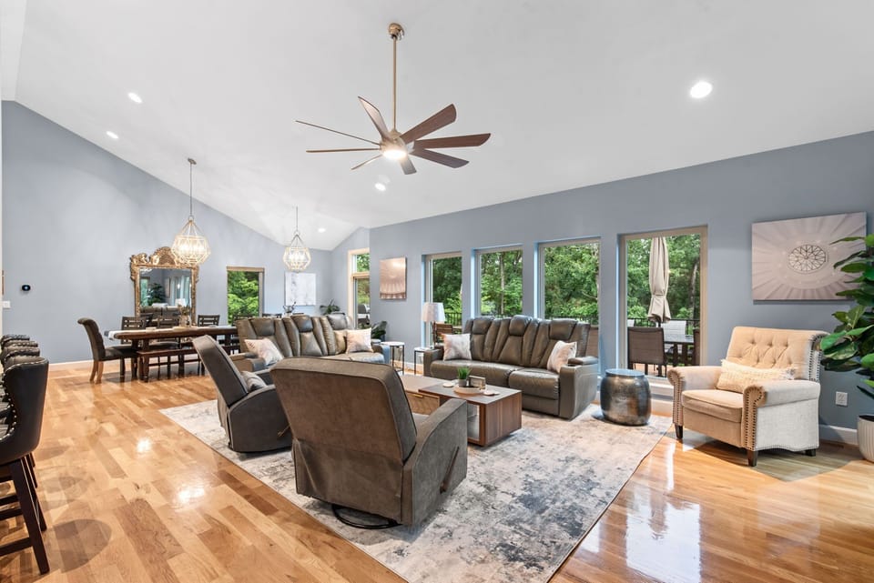 Cozy up in the spacious living area with vaulted ceilings and wooded views.