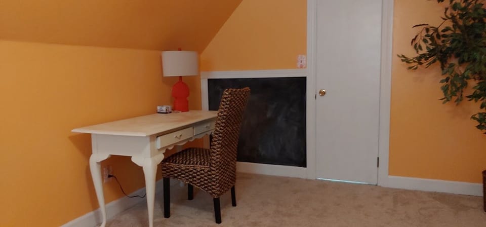 Tangerine bedroom with desk and chalk board