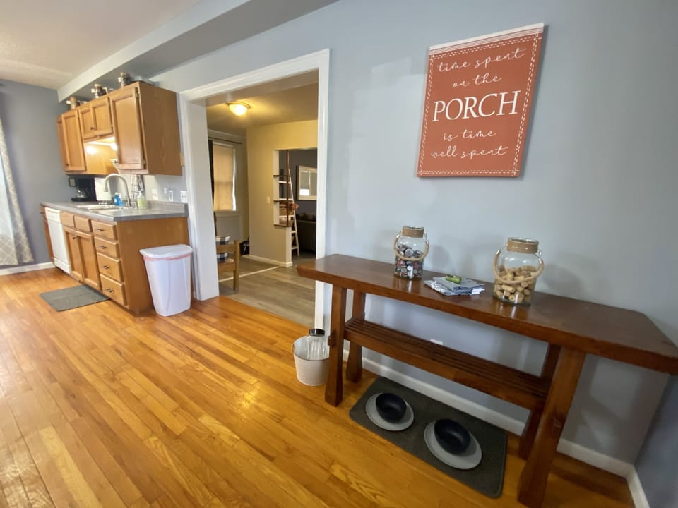 Kitchen area with pet food and water bowls under side board table