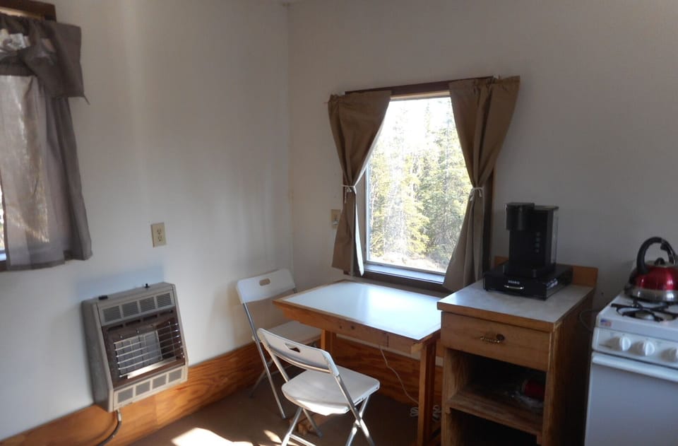 Table with two chairs. Propane heater