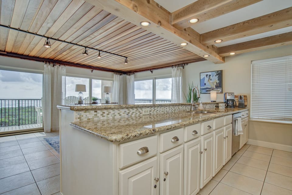 Open concept kitchen and dining area with granite countertops.