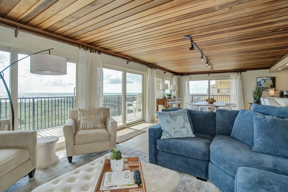 Spacious living area with comfy couches and a large flat screen TV.