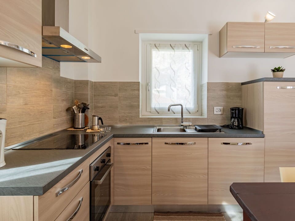 Tap, Cabinetry, Sink, Kitchen Sink, Countertop, Property, Building, Wood, Interior Design, Lighting