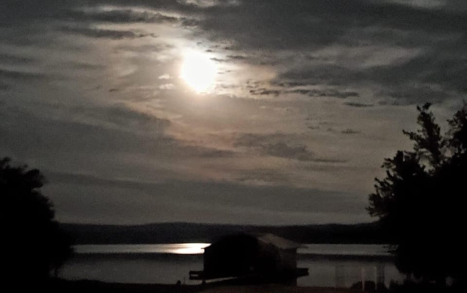 Moon rising over boathouse