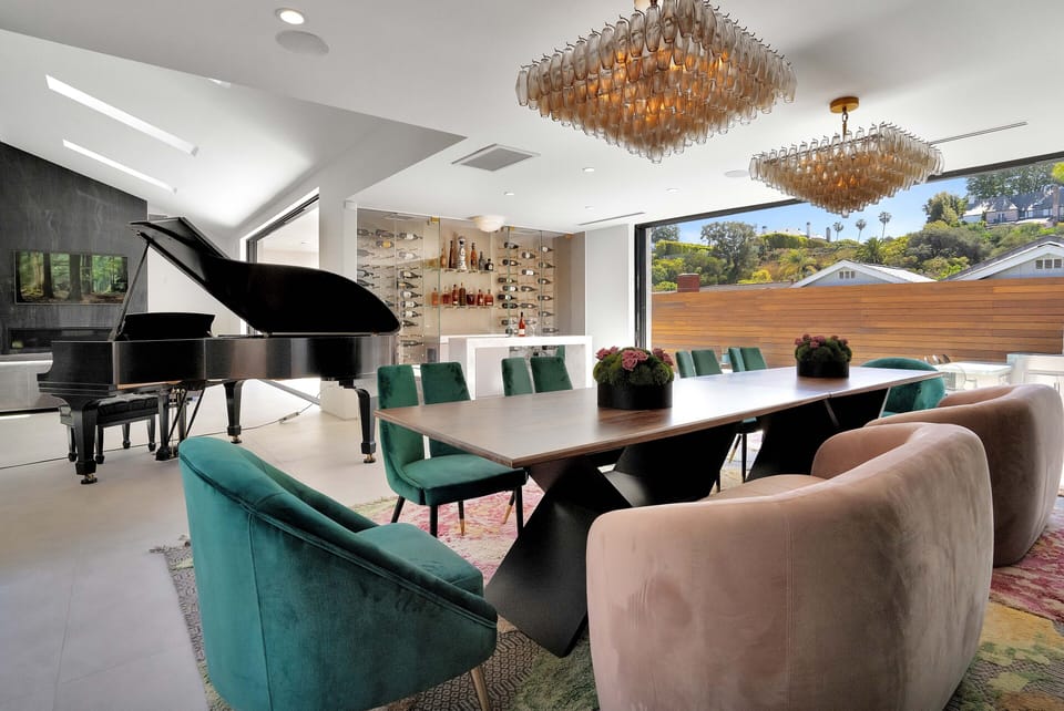 An opulent dining room, a bar with an elegant wine wall and a piano.
