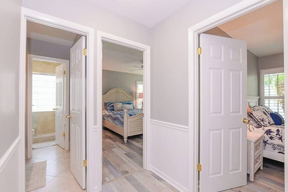 Hallway to  the guest bathroom and to two of the bedrooms.