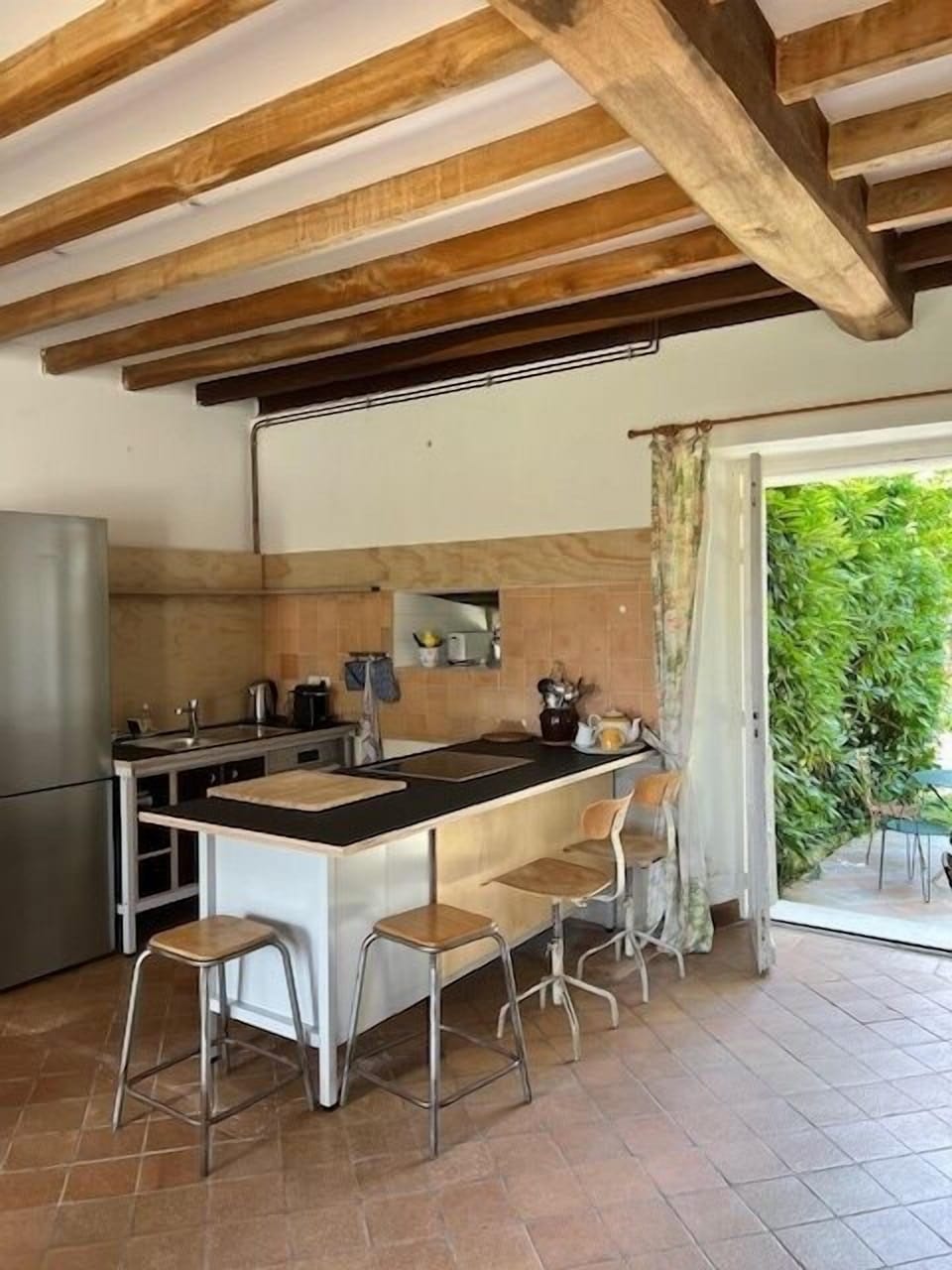 Kitchen with large fridge, electric stove, oven, dishwasher