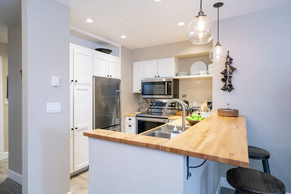 Fully stocked kitchen with sleek stainless steel appliances ideal for spending time together after a day of adventure.