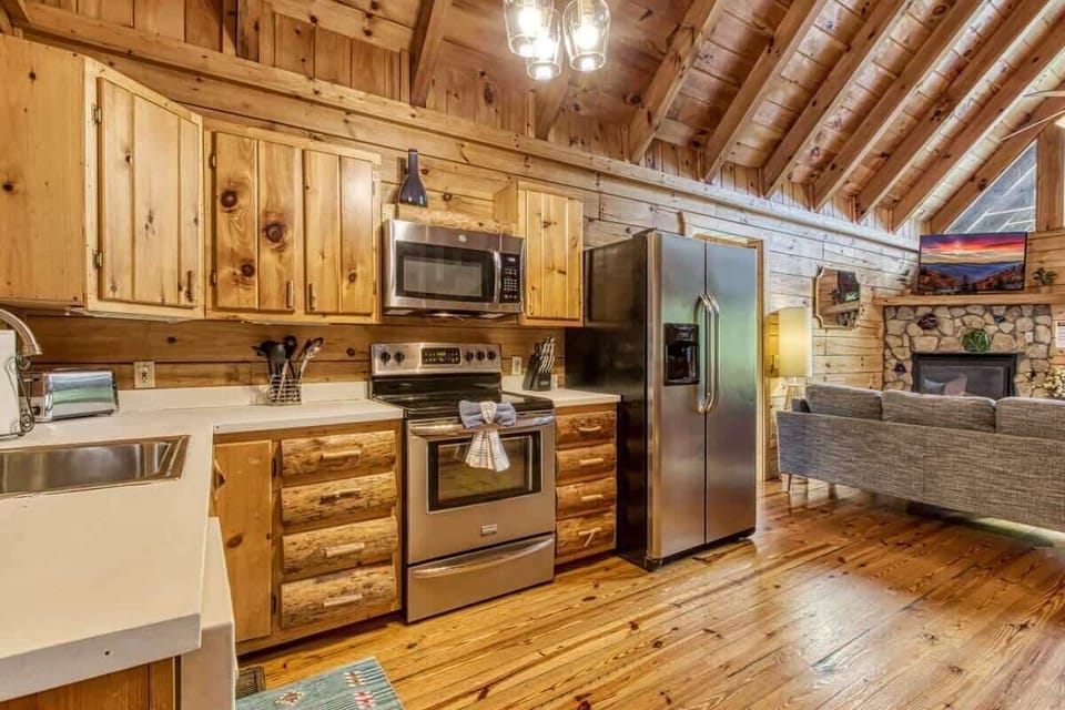 Step onto the main level, where the kitchen, living area, and primary bedroom await. From here, you can head up to the loft or down to the gaming den and an additional bedroom.