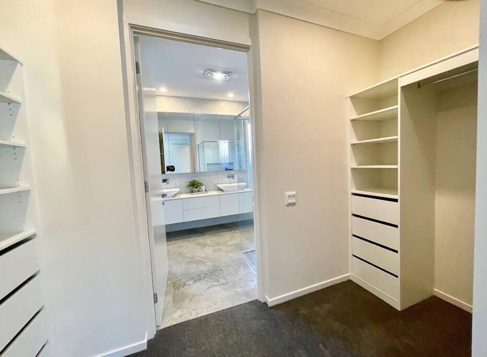 Walk-in wardrobe links the master bedroom and ensuite.
