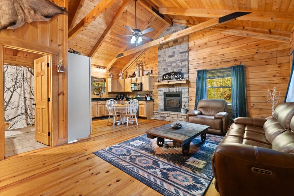 Cozy cabin living room with rustic charm and stone fireplace
