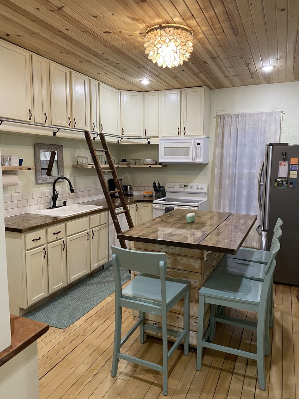 Kitchen.  Ladder can be removed.  Everyday needs are easily in reach on shelves.