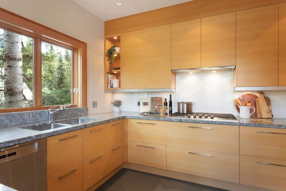 - Bright kitchen with granite counters and sleek cabinetry  
- Fully equipped for home-cooked mountain meals and gatherings  
- Forest-view window adds a peaceful cooking experience  