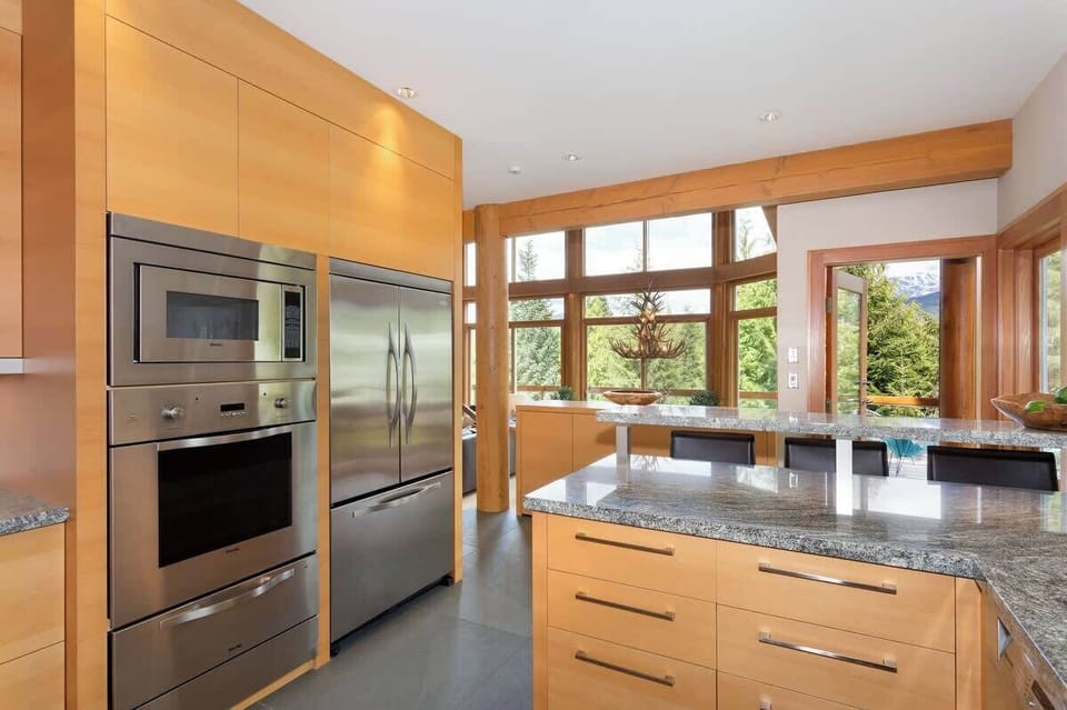 - Sleek kitchen with granite counters and modern appliances  
- Large windows fill the space with natural mountain light  
- Perfect for cooking and connecting with stunning views  