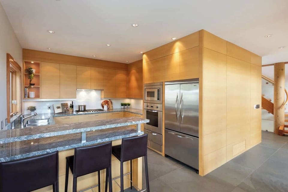 - Modern kitchen with island seating and stainless appliances  
- Granite finishes and soft lighting for effortless cooking  
- Forest-view windows bring nature right to your meal prep  
