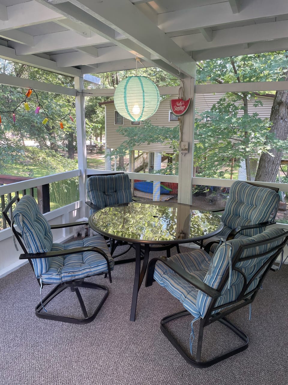 Two tables on the screen porch provide seating for 8. 