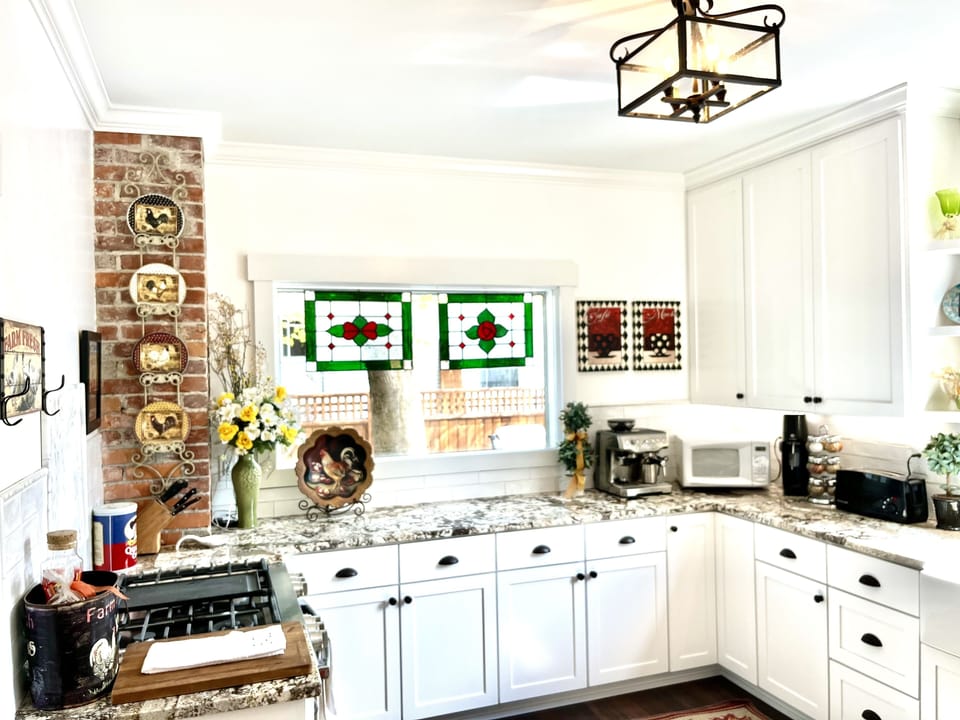 New kitchen has custom cabinetry, farmhouse sink, & granite countertops 