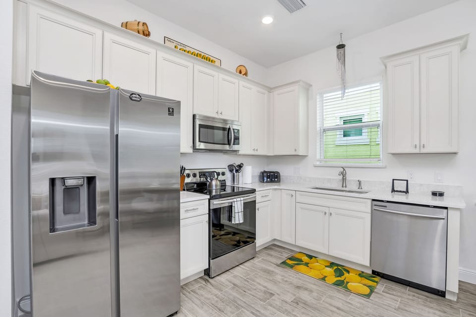 - Stylish Kitchen of the cottage in Florida - Step into the sleek ambiance of the kitchen - It  creates a modern and inviting space for culinary adventures - Thoughtful placement of kitchen essentials for easy access