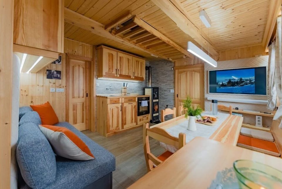 Living area with fully equipped kitchen & dining table 