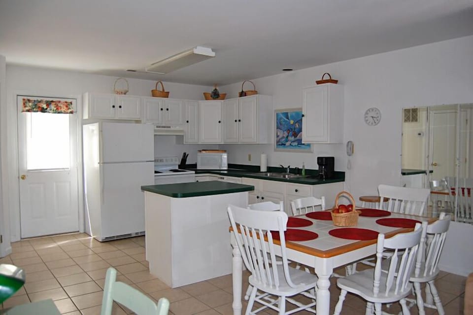 Open floor plan includes kitchen, dining & living areas, and a half bath.