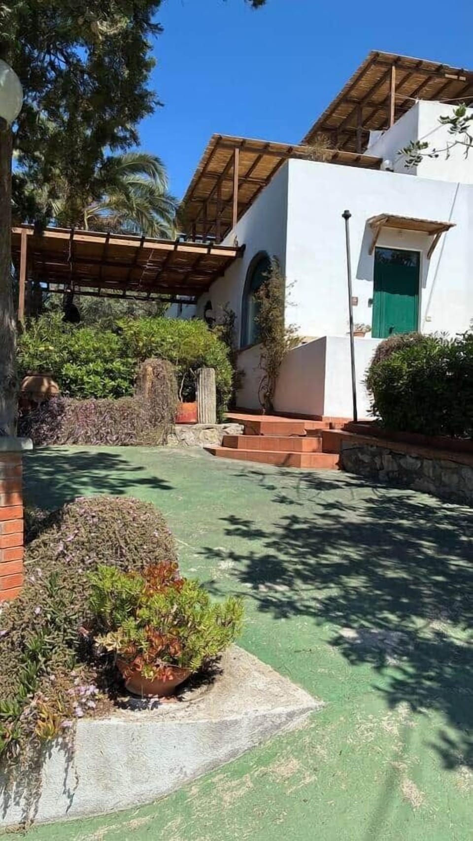 The Bougainville House exterior, nestled in the greenery of Torre Bianca in Gaeta.