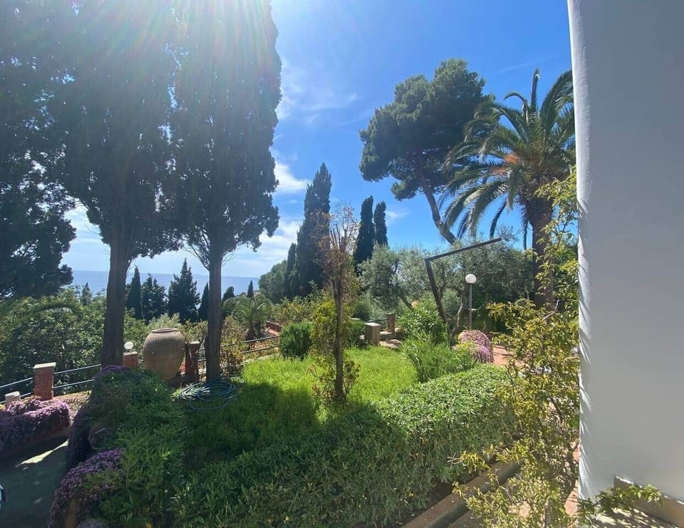The Bougainville House exterior, nestled in the greenery of Torre Bianca in Gaeta.