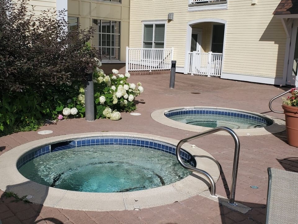 Hot tubs next to pool.