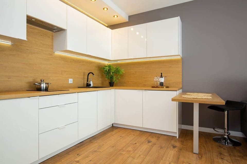 Kitchenette with kettle and refrigerator. 