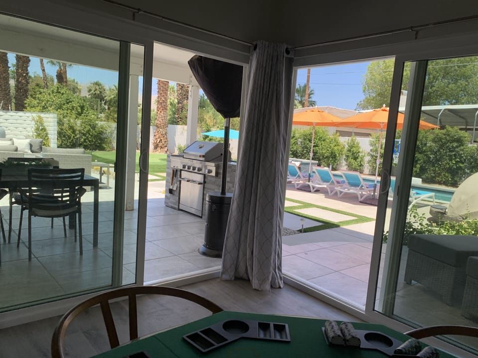 large double patio doors from the game room to the outdoor kitchen or pool