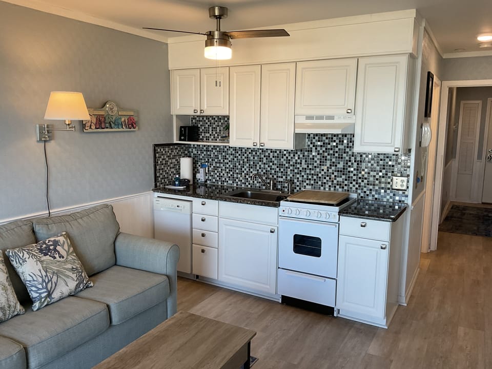Smooth top range/oven with cutting board, quiet dishwasher, in-sink drainer.