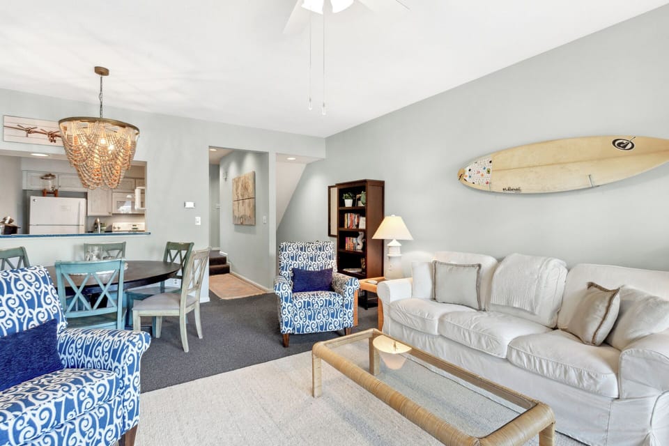 Unwind in the bright living room with comfortable furniture and enjoy your favorite show on the wall-mounted Smart TV.